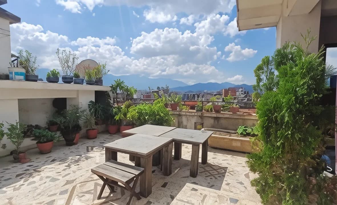 Rooftop terrace with seating and mountain views